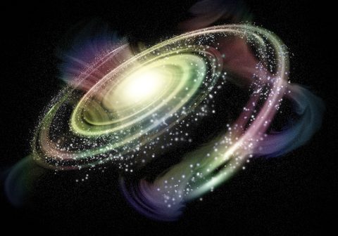 A spiral galaxy glowing in pink, green and gold against black space