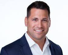 Portrait photo used for the John persona: a man in his late thirties in a collared shirt